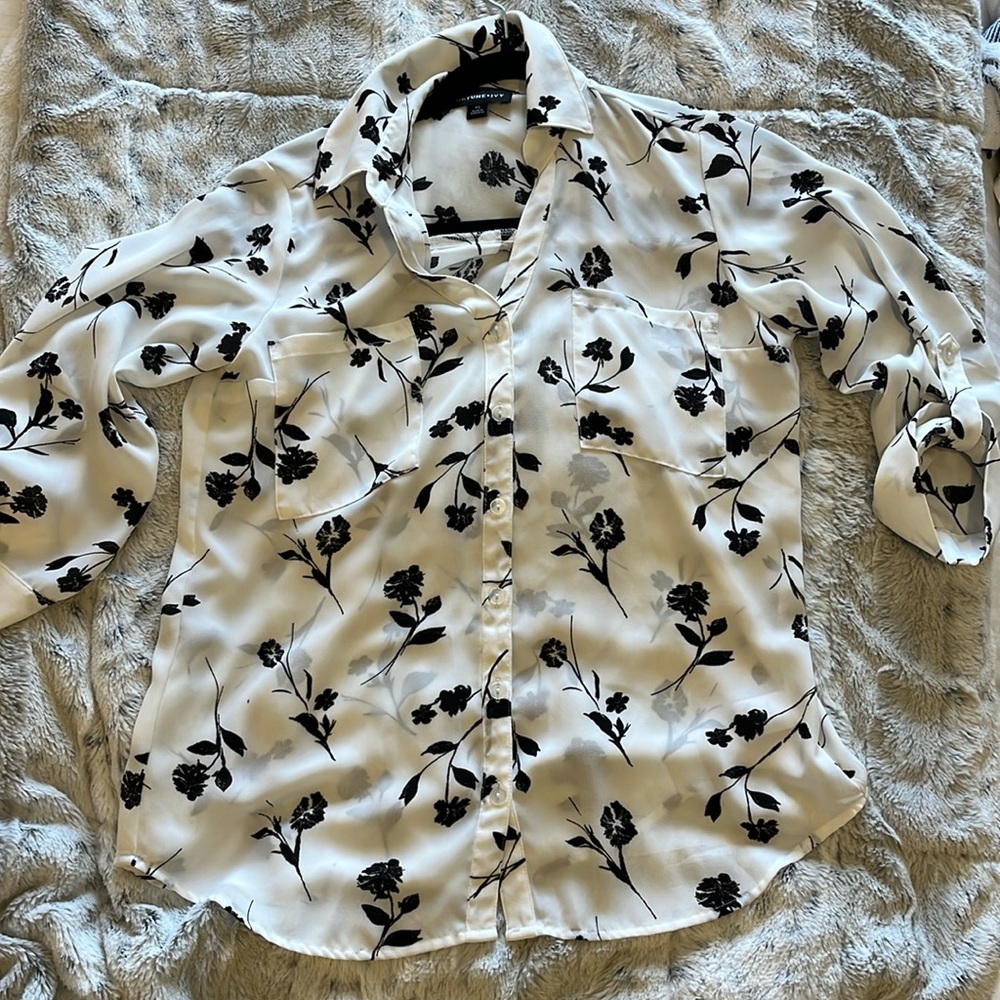 White blouse with black flowers.